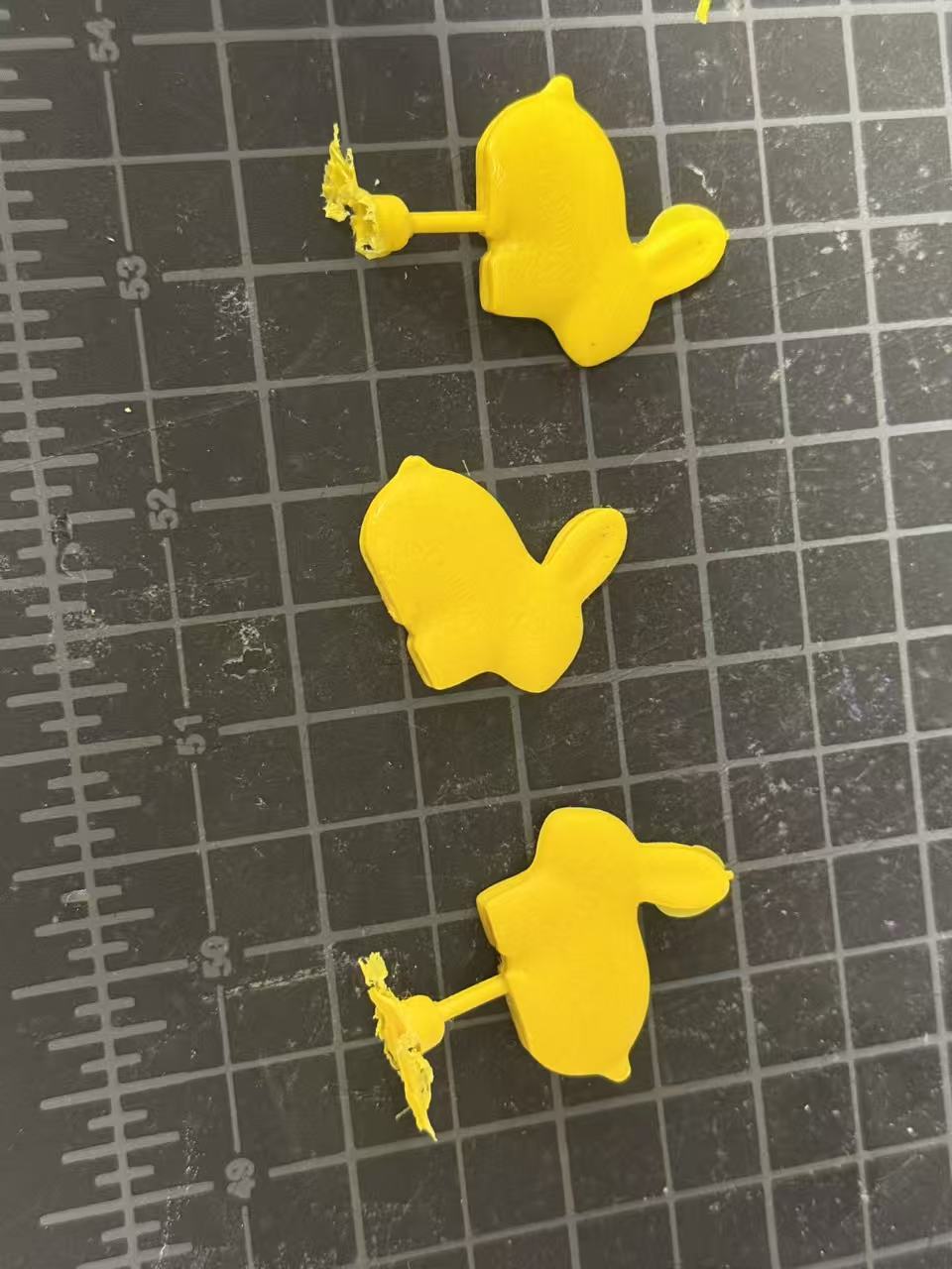 Three yellow PP injection-molded rabbit figurines