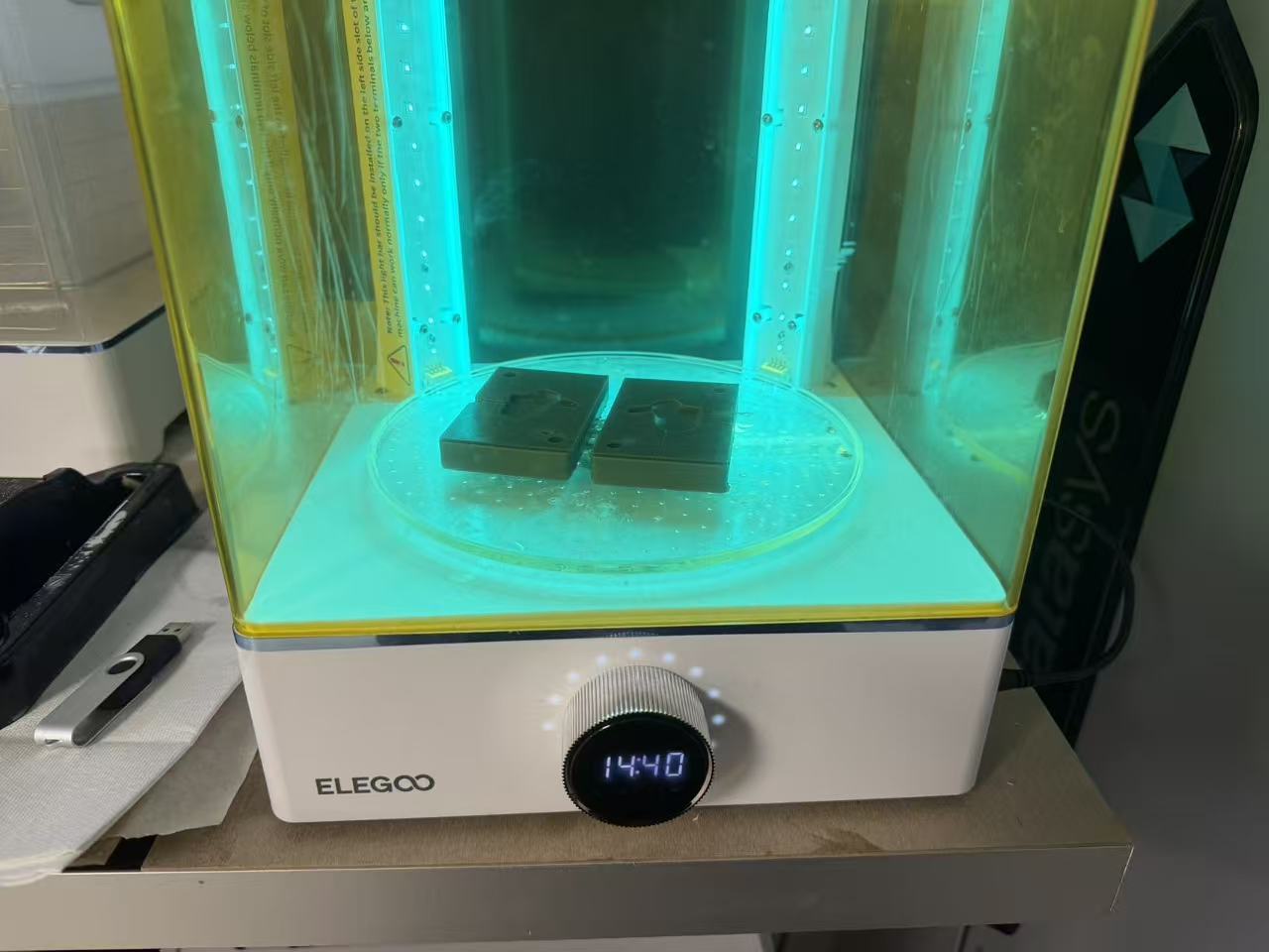SLA printed mold halves under UV curing lamp