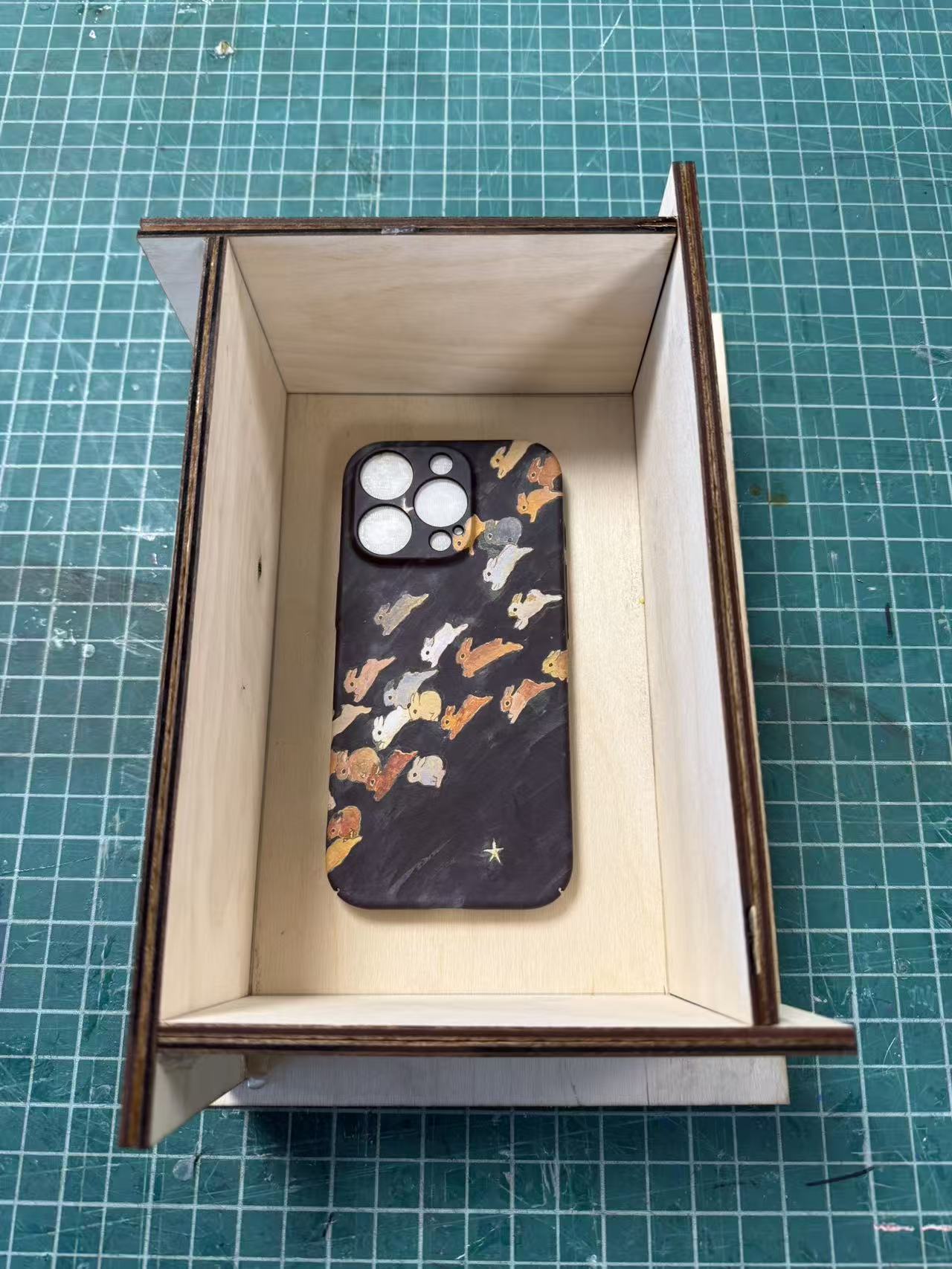 Phone case placed face-down in mold box